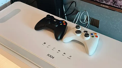 Two game controllers side by side on the media console
