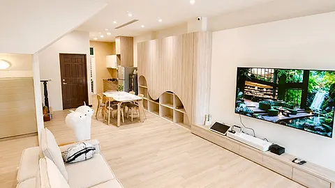 Large 75-inch TV wall in the living room with a media console and sound bar