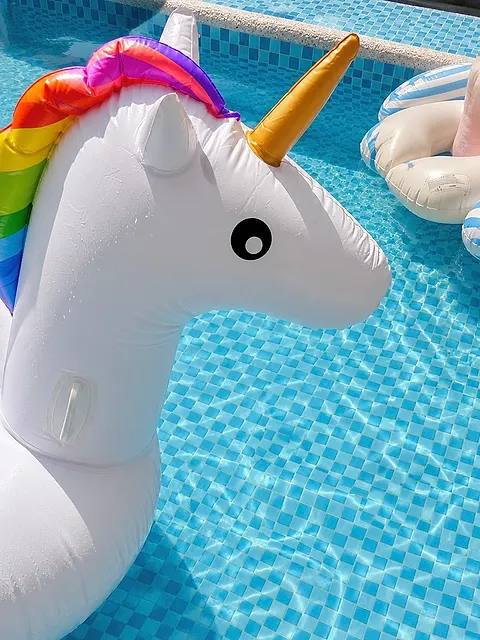 Close-up of the unicorn float against the mosaic-tiled pool