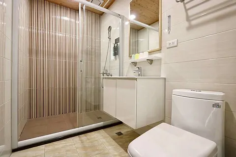 Twin-bed quad room with a round hanging mirror and wood clothes rack, with its own large terrace and pool