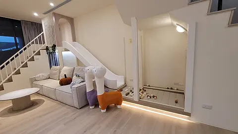 Nikoniko Family Hall’s living room with an indoor kids' slide and ball pit, plush toys on the sofa